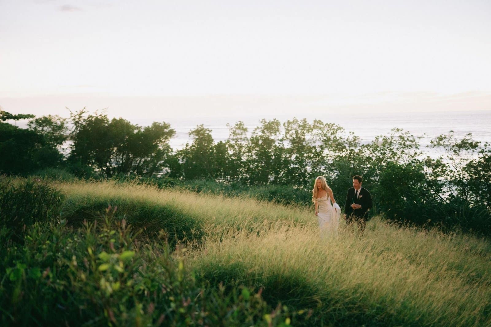 Cassie Randolph and Brighton Reinhardt sunset portrait in the tall grass, Tamarindo, Costa Rica