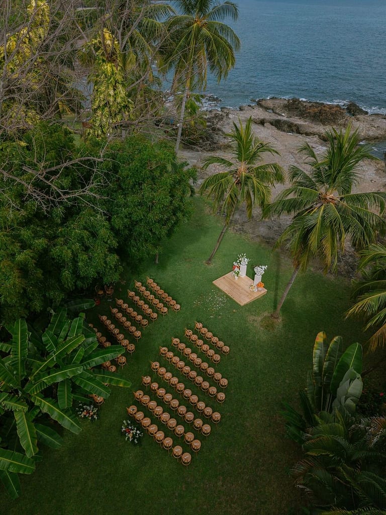 Aerial view of an oceanfront lawn set with chairs for a wedding ceremony near Montezuma, Costa Rica
