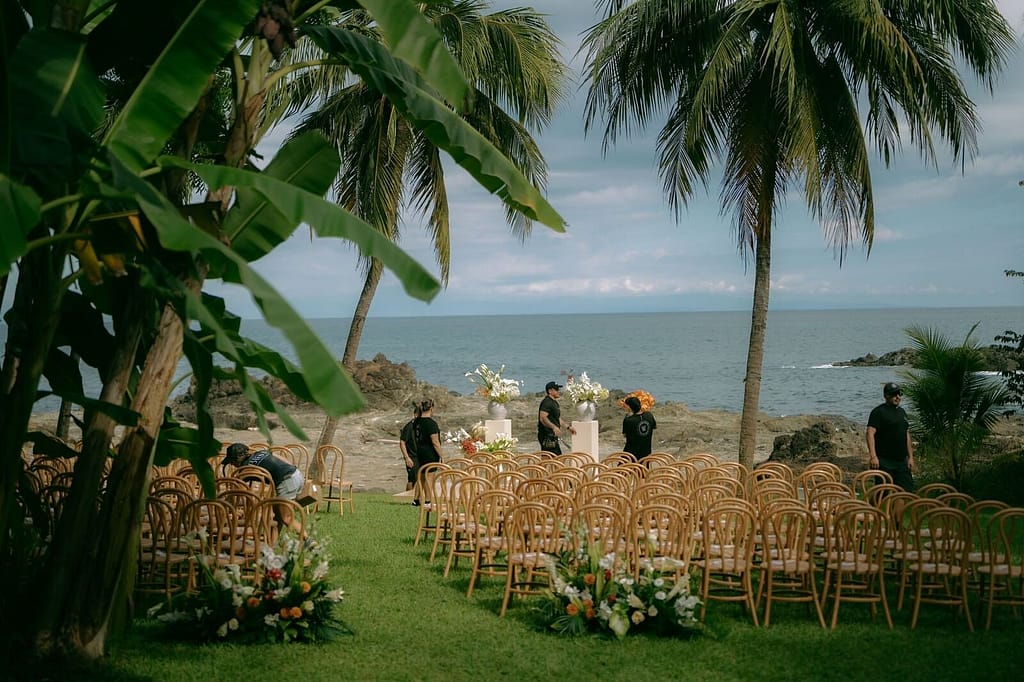 Wedding ceremony chairs facing the ocean between palm trees near Montezuma, Costa Rica