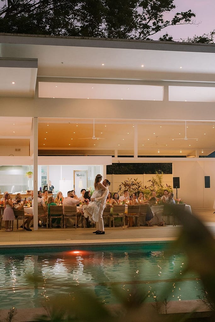 Wedding dinner in a glass-walled dining room beside the pool at dusk, Aves Hotel and Resort, Montezuma, Costa Rica