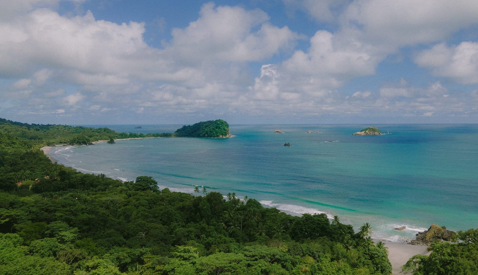 Coastline with a turquoise bay, forested headland and small islands, Costa Rica
