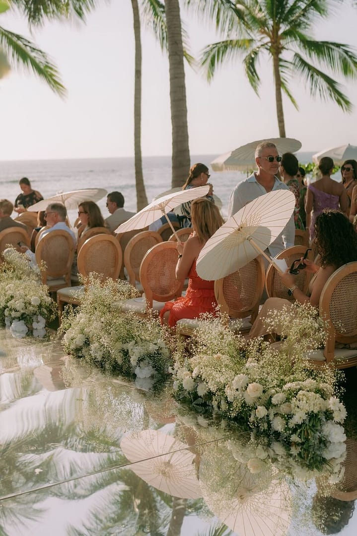 Oceanfront wedding ceremony with a floral aisle, parasols and palm trees, Costa Rica
