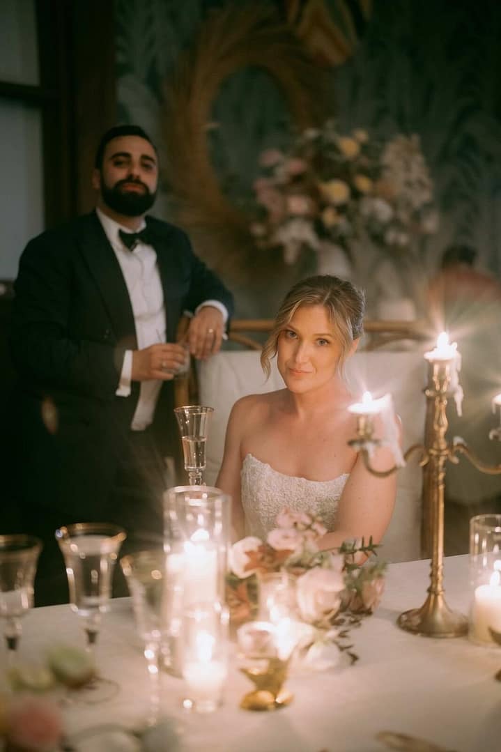 Bride and groom seated at a candlelit reception table, Costa Rica wedding reception