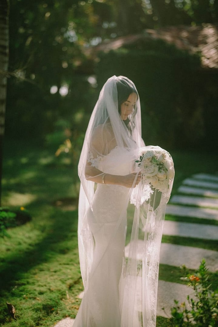 Bride in a long lace veil in a tropical garden in Santa Teresa, Costa Rica