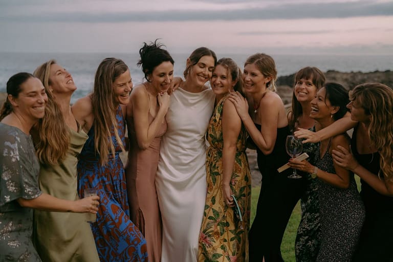 Bride laughing with her friends and bridesmaids on the coast at dusk, Costa Rica wedding